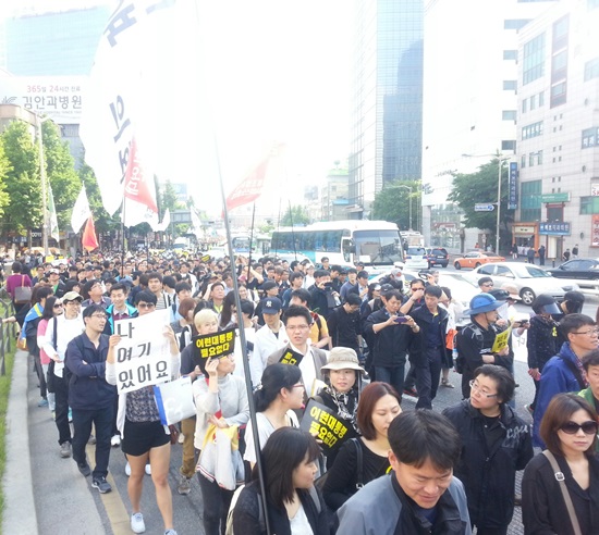 5월 1일, 서울역 광장에서 열린 2014 세계노동절대회 후 참가자들이 세월호 참사 희생자들에게 분향을 하기 위해 서울광장으로 행진하고 있다.