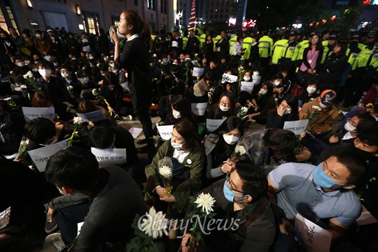 세월호 참사 희생자 추모와 무책임한 정부를 규탄하는 '가만히 있으라' 침묵행진에 참여한 시민들이 3일 오후 광화문네거리에서 피켓과 국화를 들고 행진을 벌이다 경찰에 가로막히자 연좌해서 자유발언 시간을 갖고 있다.