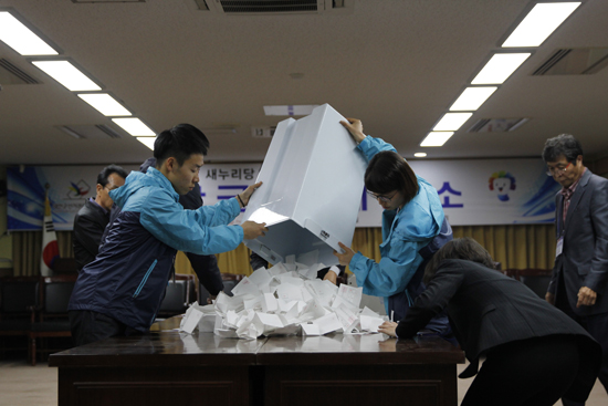 태안군선거관리위원회 관계자들이 당원선거인과 국민선거인단의 투표가 마친 이후 곧바로 투표함을 개봉하고 있다.