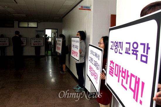  고영진 경남도교육감이 13일 오전 경남도교육청 브리핑룸에서 출마선언 기자회견을 열려고 하자 창원지역 여성, 학부모들이 '진주외고 학교폭력 학생 사망, 불출마하라'는 내용의 피켓을 들고 서 있었다.