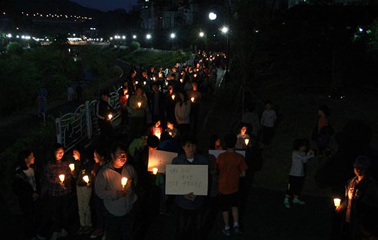 경기도 의왕시 청계마을 주민들이 어둠에 잠긴 동네를 촛불행진하고 있다.