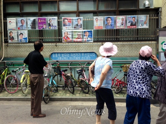 서울 강동구 성내2동 주민센터 앞, 투표에 앞서 주민들이 후보자 포스터를 보고있다. 주민들은 그러나 후보들의 '가정사 논란'만을 기억할 뿐 구체적인 교육정책이나 공약은 모르는 경우가 많았다. 