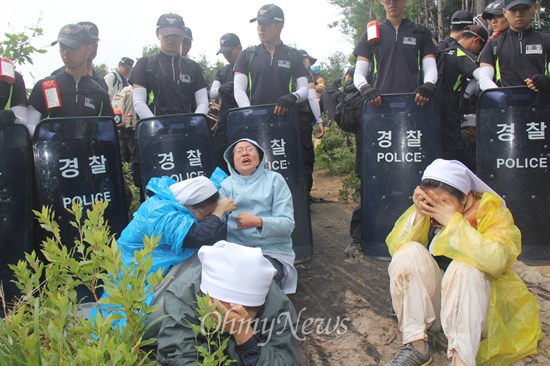 밀양시와 경찰이 11일 오전 밀양 부북면 평밭마을에 있는 129번 철탑 현장의 움막농성장을 강제철거하는 행정대집행을 단행한 뒤, 주민과 연대단체 회원들이 허탈해 하며 울부짖으며 앉아 있다.