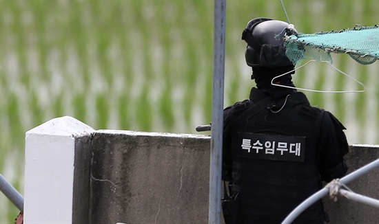  지난 22일 오후 강원도 고성군 거진읍 명파리 인근 야산에서탈영한 초병과 체포에 나선 병력들과 교전이 일어난 뒤 배치된 헌병 특수임무대 대원이 교전이 일어난 지역을 바라보며 경계를 서고 있다. 