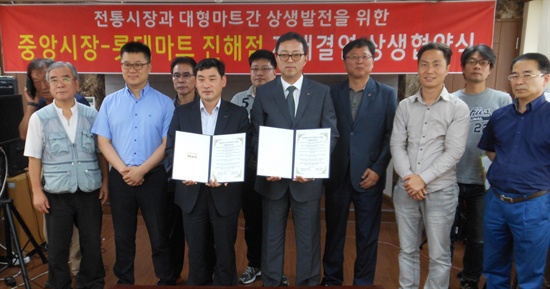 진해중앙시장 하영욱 번영회장과 롯데마트 김한묵 진해점장이 11일 상생발전과 협력을 위한 자매결연을 협약을 체결했다.