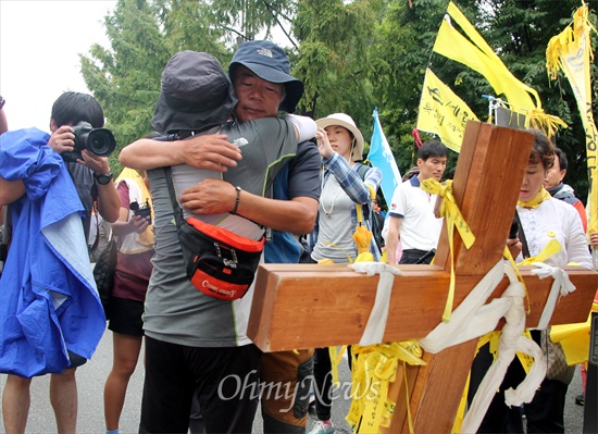  세월호 도보순례단이 14일 오전 대전월드컵경기장에 도착, 900km의 대장정을 마쳤다. 사진은 세월호 희생자 유가족인 고 김웅기 학생의 아버지 김학일씨와 고 이승현 학생의 아버지 이호진씨가 부둥켜 안고 수고했다고 인사하는 모습.