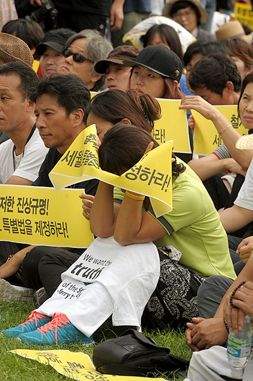 15일 오후 서울 시청광장에서 열린 '세월호 특별법 제정을 위한 범국민대회 청와대를 향한 십만의 함성'에서 한 유가족이 얼굴을 파묻은채 흐느끼고 있다.