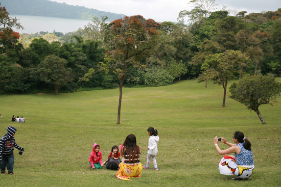 호수변 잔디밭에서 아이들이 엄마들과 즐거운 시간을 보내고 있다.
