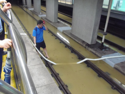 지하철 선로에 고인 물을 퍼올려 집수정으로 보내기 위한 작업을 하고 있다.