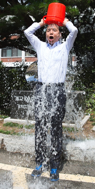  권진택 경남과학기술대학교 총장이 26일 본관 앞 '개교100주년 기념 타임캡슐' 앞에서 루게릭병 환자를 돕기 위한 '얼음물 샤워'를 하고 있다.