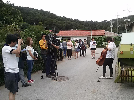 작가 겸 재미 첼리스트 이옥경은 더 이상 쓰이지 않는 정미소 앞에서 첼로 포퍼먼스를 하고 있다. 첼로의 울림이 얼마나 큰 지 주변 사람을 놀라게 한다. 이 연주는 정미소 안에 들어가서도 계속되었다