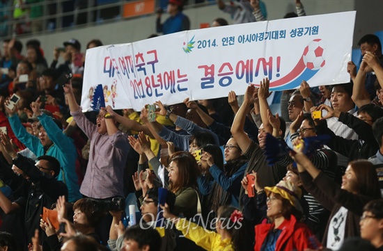 '한국 여자축구 2018년에는 결승에서'  한국 여자축구대표팀이 1일 오후 인천축구전용경기장에서 열린 '2014 인천아시아경기대회' 여자축구 동메달 결정전 베트남과의 경기에서 3대 0으로 완승하며 동메달을 획득하자, 시민들이 '2018년에는 결승에서'라는 피켓을 들어보이며 격려하고 있다.
