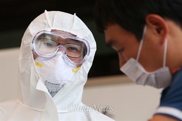 송탄보건소 의료진이 열이 나서 방문한 시민에게 증상을 확인하고 있다.