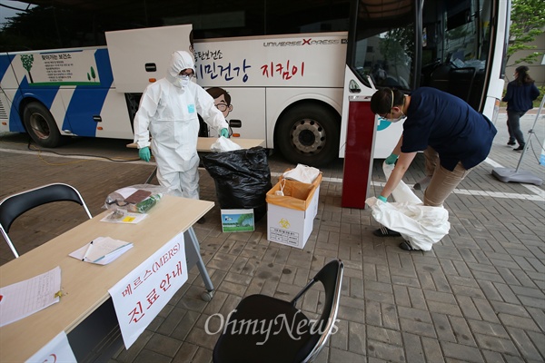  진료시간이 끝난 뒤 송탄보건소 의료진들이 하루종일 착용했던 전신방호복을 벗고 있다.