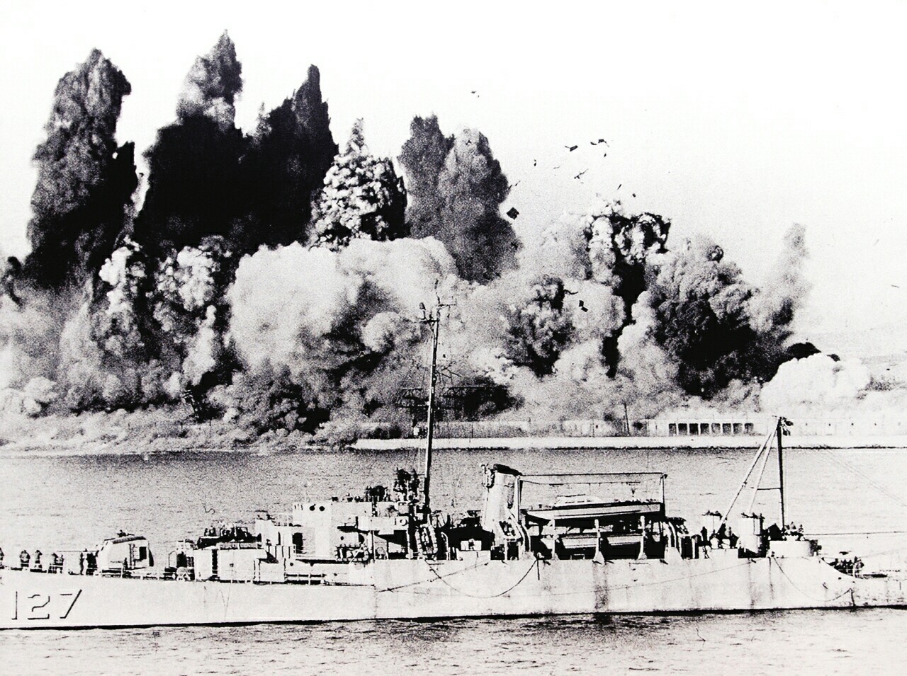 흥남철수작전을 지원하고 있는 미해군의 127전함과 폭파 되어 불타고 있는 흥남함(1950.12.24)