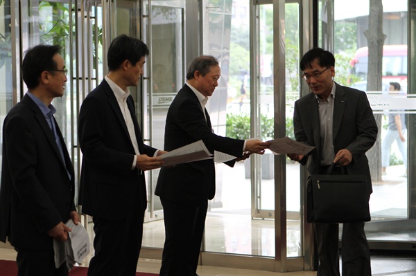 대우조선해양 팀장 이상 임원들이 서울 본사에서 직원들에게 결의문을 나눠주고 있다.