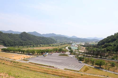 장성호 제방에서 내려다 본 풍경. 수변공원 주차장 너머로 장성 읍내와 들녘이 내려다보인다. 가운데로 가로지르는 도로가 순천-대전 간 호남고속국도다.