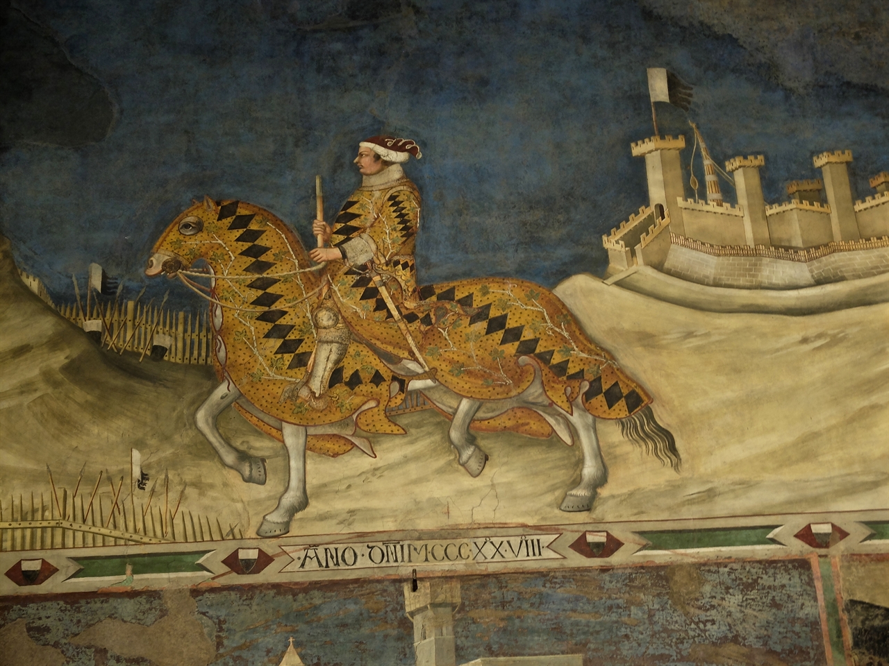 시모네 마르티니, '구이도리초 다 폴리아노 장군'(부분), 시에나 푸블리코 궁전. 주위 도시들을 정복하고 돌아오는 장군의 모습을 당당하게 묘사한 이 그림은 전성기 시에나의 영광을 상징하는 작품입니다.