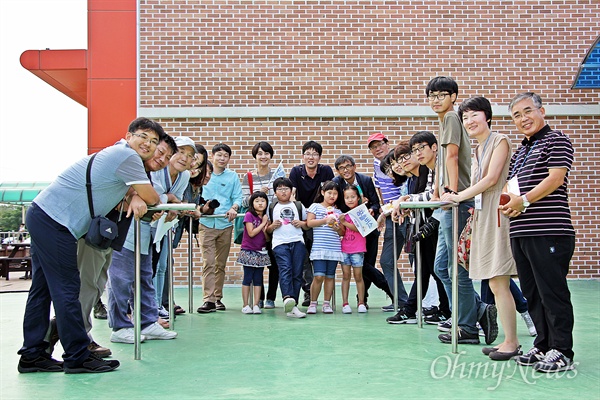 11일 인안초등학교를 찾은 꿈틀버스단이 학교 교사·학생들과 카메라 앞에서 포즈를 취하고 있다.