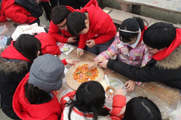 한국실명예방재단이 주최한 겨울 오감체험 일일캠프. 저시력 아동들이 피자 만들기 활동을 하고 있다.