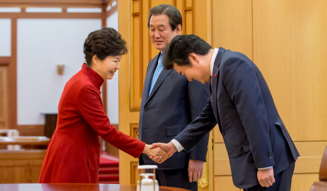2015년 7월, 새로 새누리당 원내대표가 된 원유철 의원이 김무성 대표와 함께 청와대를 방문하여 박근혜 대통령과 악수하고 있다.