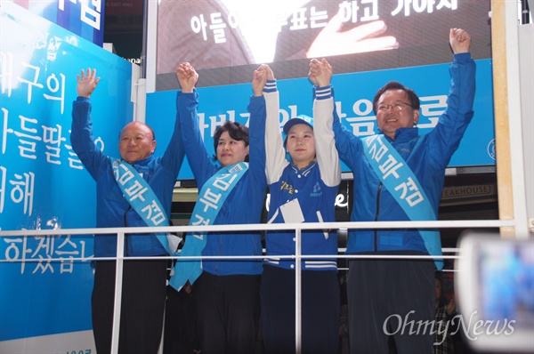 대구 수성갑 선거구에 출마한 김부겸 후보가 자신의 아버지와 부인, 막내딸 등과 함께 손을 들어 인사를 하고 있다.