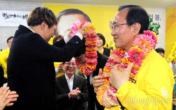 '창원성산' 국회의원선거에서 당선한 정의당 노회찬 후보가 13일 저녁 선거사무소에서 지지자로부터 부인 김지선씨와 꽃다발을 받고 있다.