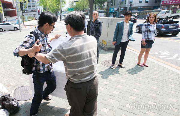 인터넷 닉네임 '둥글이'로 알려진 박성수씨가 29일 오후 서울 종로구 어버이연합 사무실 앞에서 피켓을 들고 청와대의 어버이연합 관제데모 지시 의혹 및 1인시위방해 등을 규탄하며 '어버이연합 해체'를 촉구하는 1인 시위를 하던 중 어버이연합 회원에게 피켓을 빼앗기는 등 방해를 받고 있다.