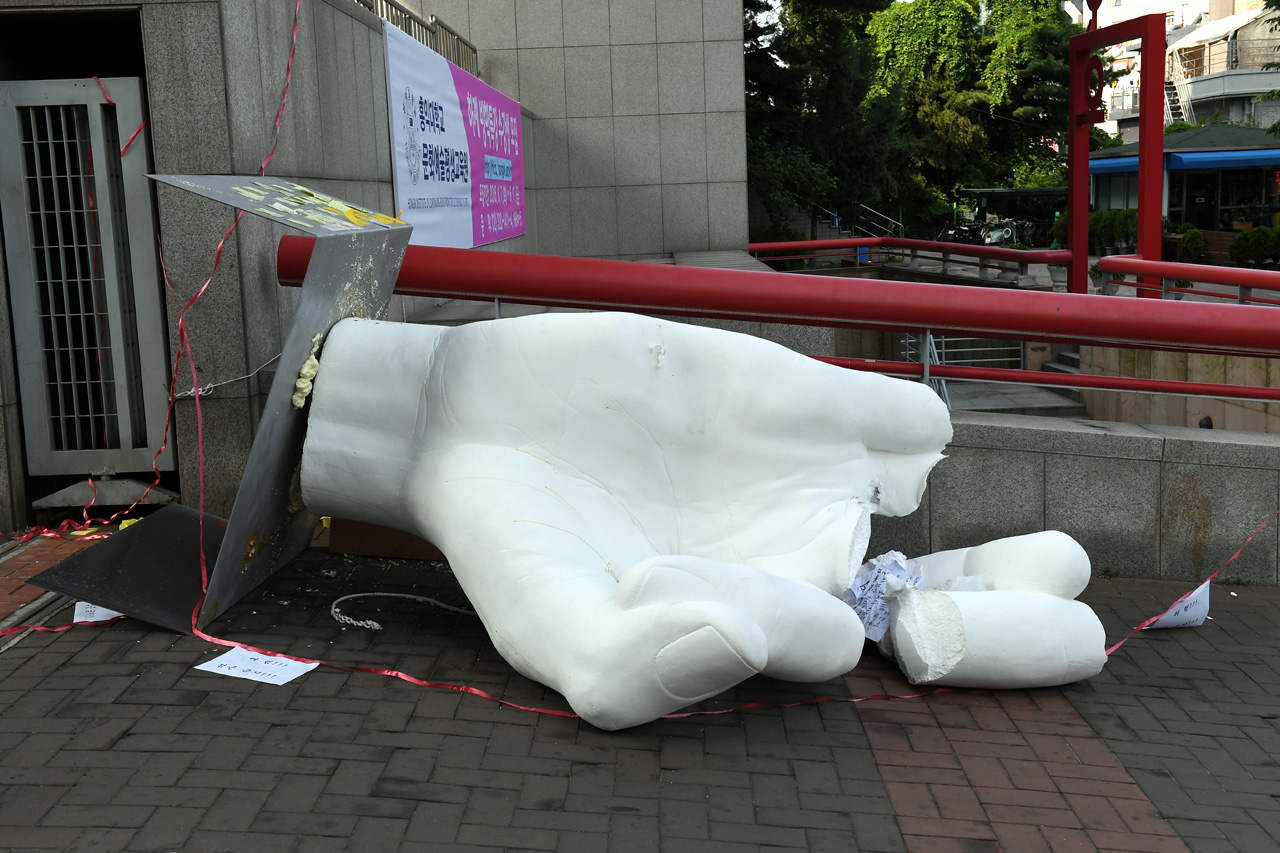 1일 오전, 홍익대학교 정문에 설치된 '일간베스트저장소(일베)' 상징 조형물이 부서진 채 길가에 나뒹굴고 있다.
