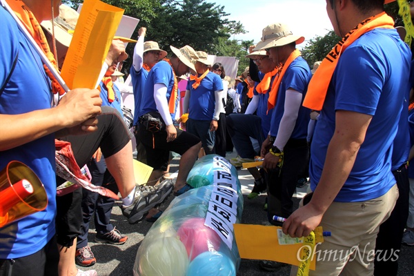 전쟁반대 평화실현 경남비상시국회의는 23일 오후 진해 미군사고문단 앞에서 "사드배치 반대, 평화협정 체결, 경남평화대회"를 열었고, 참가자들이 주한미군 물러가라고 적힌 고무풍선을 발로 터뜨리고 있다.