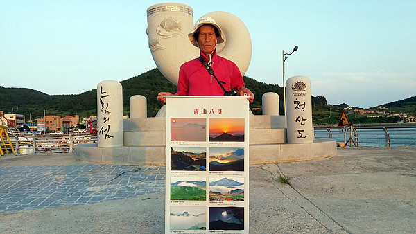 귤은 김유 선생이 선정한 청산팔경을 촬영하기 위해 4년 동안 7860장의 사진을 찍어 8장을 완성한 김광섭 사진작가가 자신의 작품을 들어보이고 있다. 청산면지에도 소개됐다