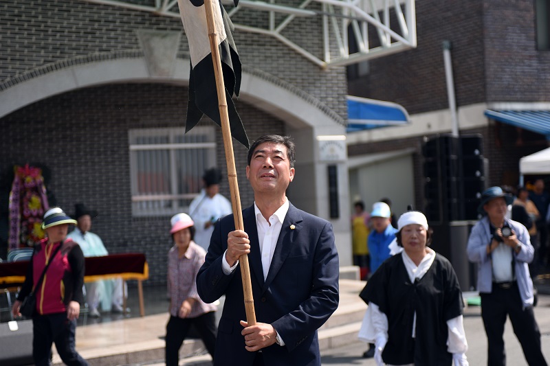 아홉째마당에서 김형도 논산시의회의장이 깃발을 들고 흥겨운 마당놀이를 즐기고 있다.