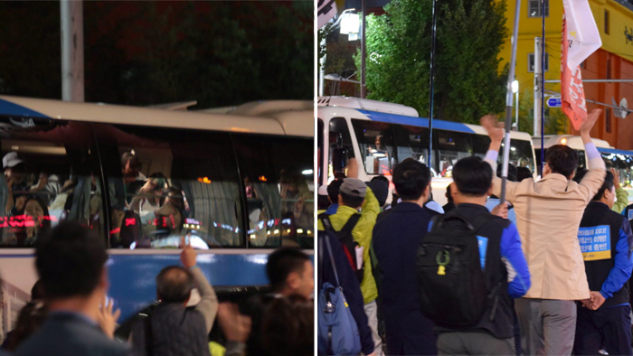 버스 안에서 힘내라며 환호해 주는 부산시민들을 향해 손을 흔들어 답례하는 공공운수 노동자들