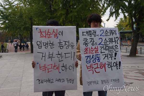 경북대 졸업생과 학생들이 27일 오전 경대 북문 앞에서 2순위 총장 임명에 항의하고 박근혜 대통령의 하야를 촉구하는 1인 시위를 하고 있다.
