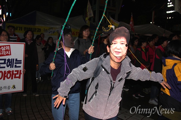 시민과 학생들이 28일 저녁 창원 한서병원 앞 광장에서 '박근혜 대통령 하야'를 촉구하는 선전전을 벌이면서 박근혜 대통령과 최순실씨의 인형을 쓰고 '꼭두각시를 선보이고 있다.