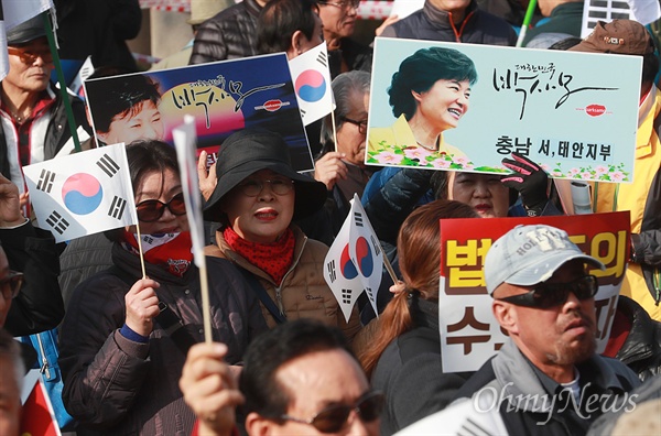 보수단체, 박근혜 하야 반대 맞불집회 박근혜 대통령의 퇴진을 촉구하는 대규모 촛불집회가 전국 곳곳에서 열릴 예정인 가운데, 19일 오후 서울 용산구 서울역광장에서 박근혜를 사랑하는 모임(박사모)를 비롯한 보수단체 회원들이 박 대통령의 퇴진에 반대하는 맞불집회를 열고 있다.
