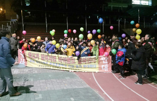 지난 24일 오후 7시 인천 용정초교 운동장에서 열린 학교 이전재배치(안) 부결 촉구 달빛 밟기 행사의 모습. 참가자들이 학교 존속과 발전을 염원하는 풍선 날리기를 하고 있다.