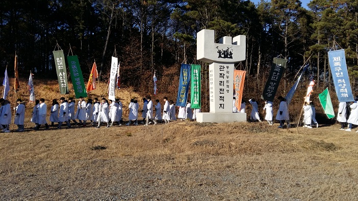 덕산고등학교 학생들이 예산농학혁명기념공원에서 동학혁명기념비 주변을 돌며 행진을 하고 있다. 