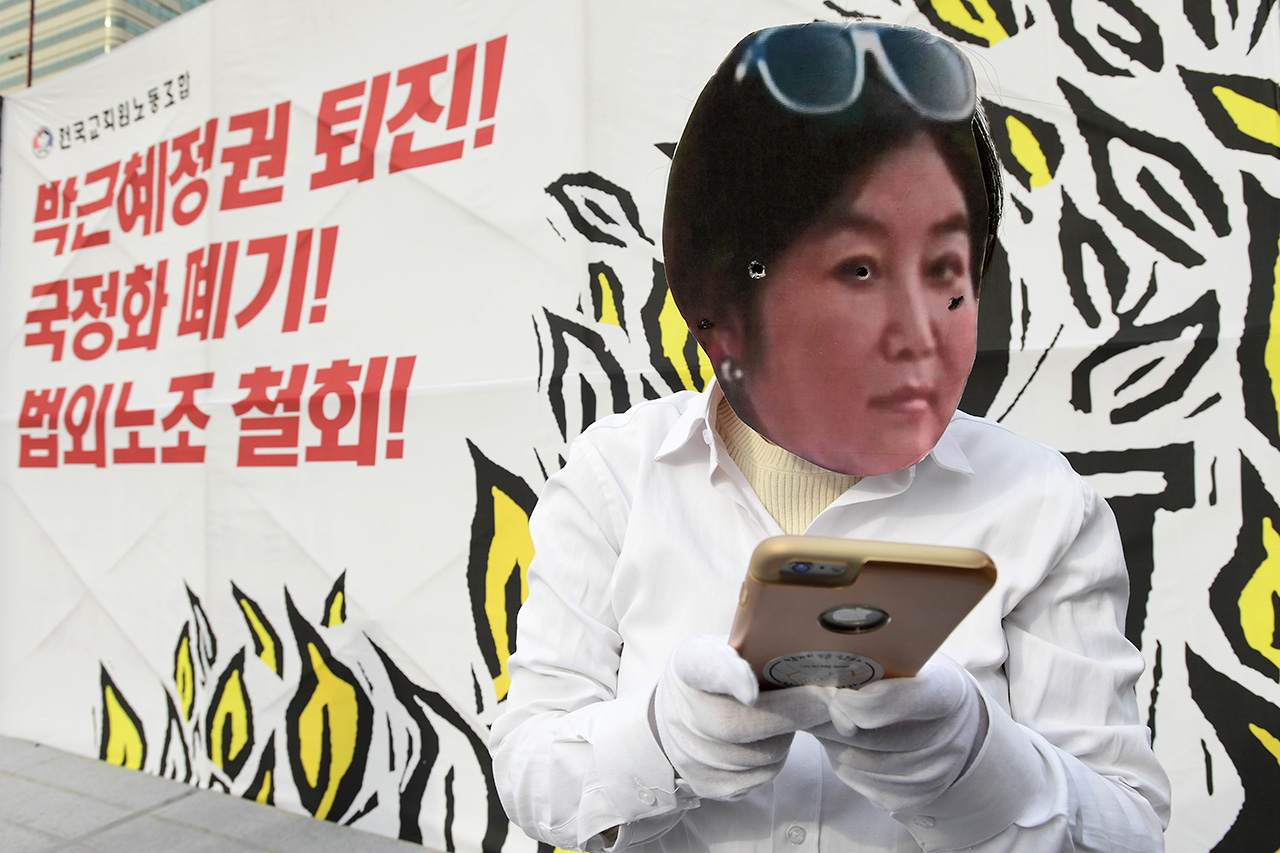 전국교직원노동조합 소속 교사들이 30일 오후 서울 중구 파이낸셜센터 앞에서 '전국교사결의대회'를 개최하고 "국정 역사교과서 폐기, 박근혜 대통령 퇴진"을 요구하고 있는 가운데 한 참가자가 최순실을 풍자한 퍼포먼스를 펼치고 있다. 