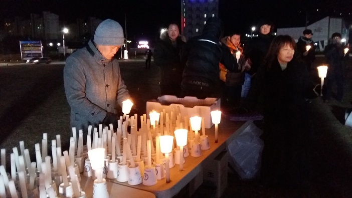 보령시민이 촛불집회에 쓰일 양초에 불을 붙이고 있다. 