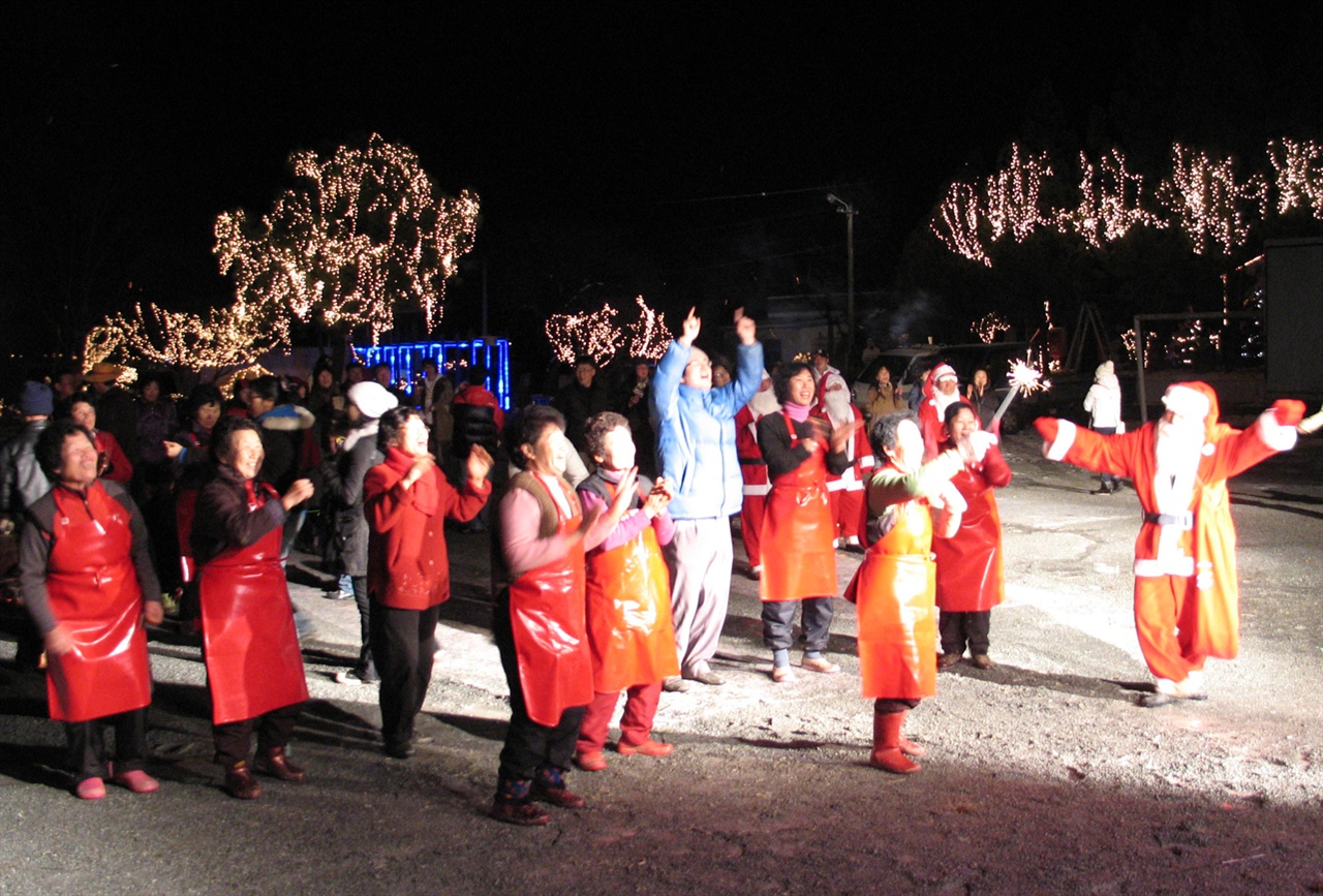 이슬촌 크리스마스 축제를 찾은 관광객과 주민이 공연을 보며 즐거워하고 있다. 단촐하지만 소소한 아름다움이 묻어나는 축제판이다.