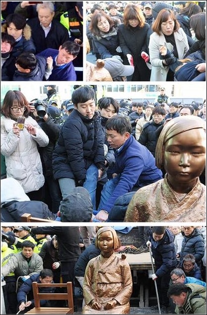 부산동구청 직원들이 주부산일본총영사관 앞에 설치된 소녀상을 지키는 시민과 학생을 강제로 끌어내는 모습