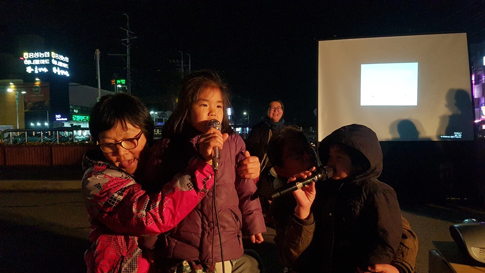 154차 홍성 세월호 참사 추모 촛불문화제에 참석한 어린아이들이 올해는 따뜻한 봄을 맞이하자며 홍성군민들과 함께 노래를 부르고 있다. 