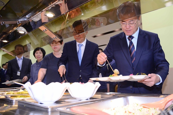 문재인 대통령이 12일 오후 청와대 여민2관 직원식당에서 기능직 직원들과 오찬을 하기 위해 식판에 손수 음식을 담고 있다.
