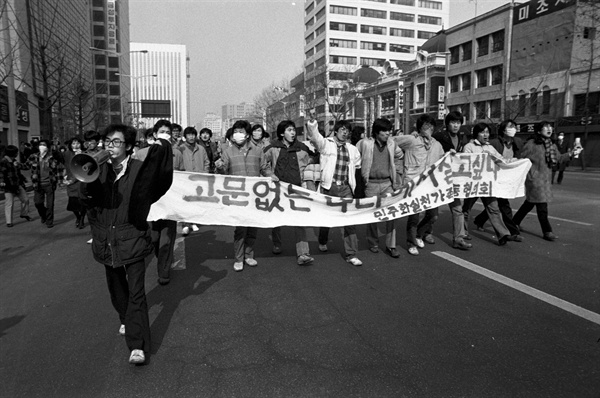 1987년 2월 7일 '2. 7 고 박종철 군 국민추도회'를 마친 시민들과 학생들이 "고문 없는 나라에서 살고 싶다"는 플래카드를 들고 가두 시위를 전개하는 모습