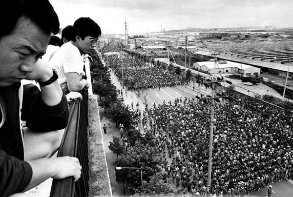1987년 8월 파업을 결의하고 거리 행진에 나선 노동자들과 이 모습을 옥상에서 바라보는 시민들