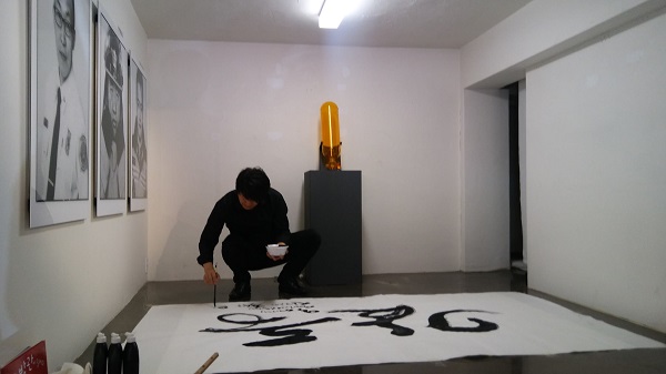 'FILO 46 47 소방관 전시회'에서 드로잉 아티스트 김정기 캘리그라퍼가 소방관을 위해 <감동>이라는 글을 써 보이고 있다. 