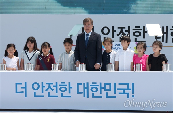  문재인 대통령이 19일 오전 부산 기장군 한국수력원자력 고리원자력본부에서 열린 고리 1호기 영구정지 선포식에 참석해 지역 어린이들과 손을 맞잡고 있다. 