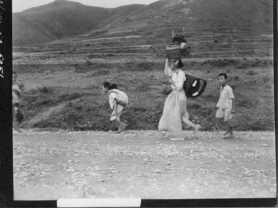  1950. 7. 29. 경북 영덕. 한 가족이 포화에 쫓기며 피란길을 떠나고 있다.