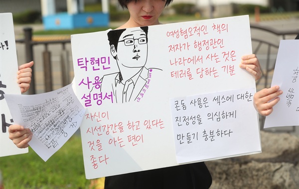 23일 오후 청와대 분수대 앞 광장에서 여성단체 불꽃페미액션 회원이 탁현민 청와대 행정관 해임을 요구하는 피켓을 들고 있다